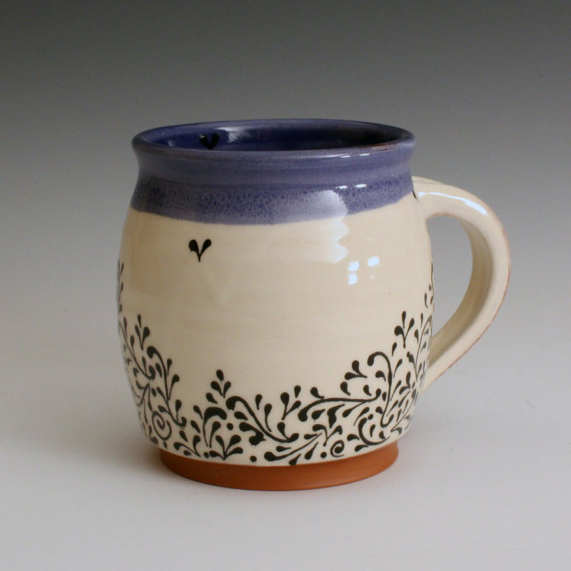 Blue and white hand made mug with hand decorated fine line black decoration. Handmade with red earthenware clay and food safe glazes.
